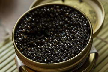 Image showing Black caviar in small round metal tin 