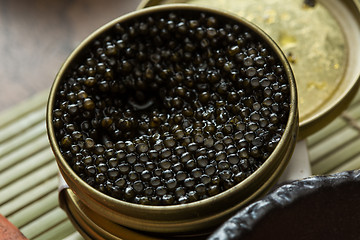 Image showing Black caviar in small round metal tin 