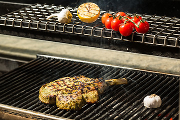 Image showing steak flame broiled on a barbecue