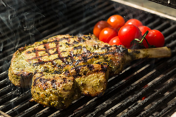 Image showing steak flame broiled on a barbecue