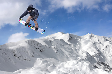 Image showing Jumping snowboarder