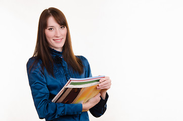 Image showing Portrait of girl in office clothes and with magazines 