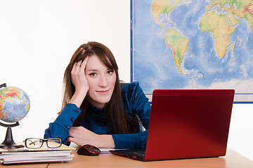 Image showing Young teacher of geography has earned for laptop