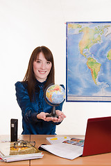 Image showing Young employee travel company with a globe in his hand