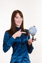 Image showing Young girl pointing at globe