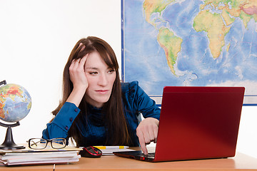 Image showing Travel agency manager tired and evil looks in the laptop