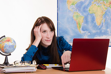 Image showing Tired geography teacher at a laptop