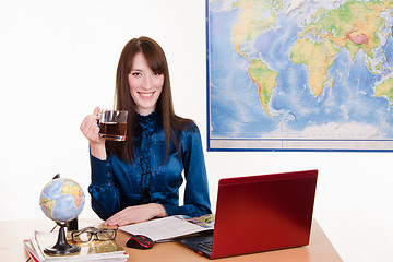 Image showing Manager a travel agency with mug of tea in hand