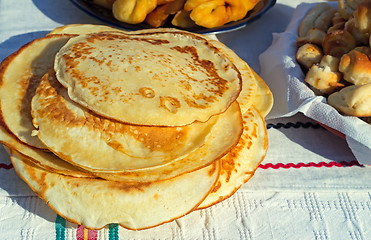 Image showing Pancakes and muffins on the table.