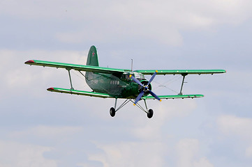 Image showing The green An-2 plane in the sky.