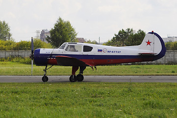 Image showing The Yak-18t plane on a runway.