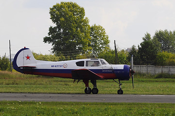 Image showing The Yak-18t plane on a runway.