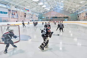 Image showing Warm-up before game of children ice-hockey teams