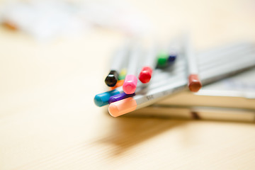 Image showing Close up of color pencils with over wooden background