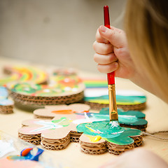 Image showing Little female baby painting with colorful paints