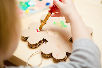 Image showing Little female baby painting with colorful paints