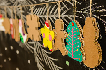 Image showing Cardboard toys for the Christmas tree or garland. Creative decorations. Selective Focus