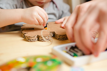 Image showing Little female baby painting with colorful paints