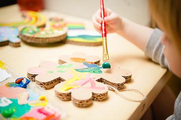 Image showing Little female baby painting with colorful paints