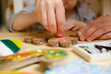 Image showing Little female baby painting with colorful paints