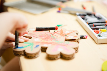 Image showing Little female baby painting with colorful paints