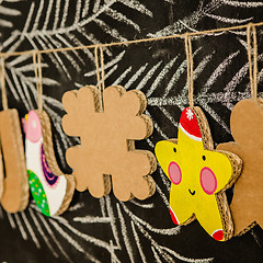 Image showing Cardboard toys for the Christmas tree or garland. Creative decorations. Selective Focus