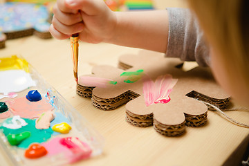 Image showing Little female baby painting with colorful paints