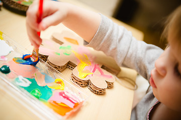 Image showing Little female baby painting with colorful paints