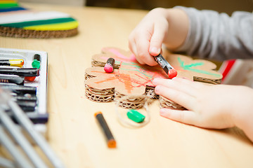 Image showing Little female baby painting with colorful paints