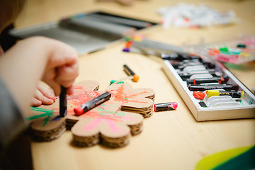 Image showing Little female baby painting with colorful paints