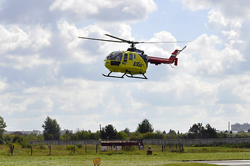 Image showing The small yellow helicopter of Utair airline in the sky.