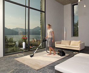 Image showing housewife with vacuum cleaner