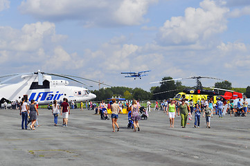 Image showing Air show. Helicopters and the flying plane in the sky.