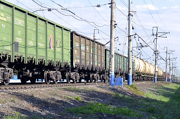 Image showing The cargo train on rails in the summer afternoon.