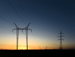 Image showing Large transmission towers at sunset