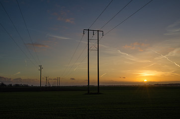 Image showing Power lines rows at sunset