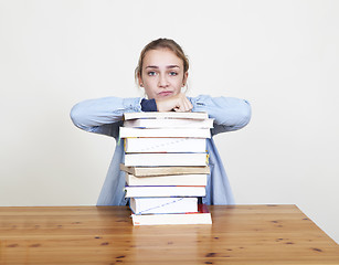 Image showing Schoolgirl with pile of books