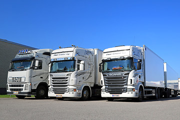 Image showing Fleet of White Scania and Volvo Trucks on a Yard