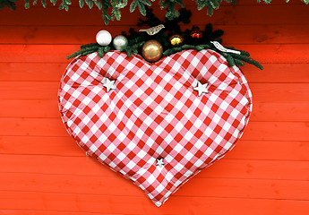 Image showing Big heart hanging on red