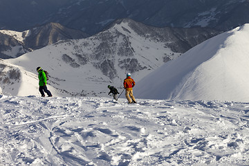 Image showing Freeriders on off-piste slope in sun evening