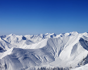 Image showing Winter mountains and chair-lift at nice day