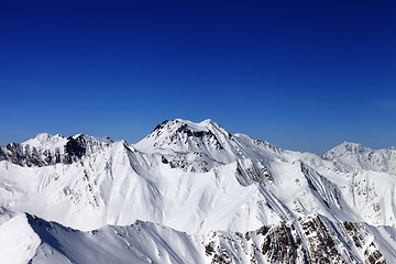 Image showing Snowy mountains in sun day