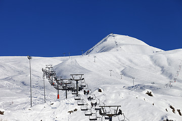 Image showing Winter mountains and ski slope at nice sun day