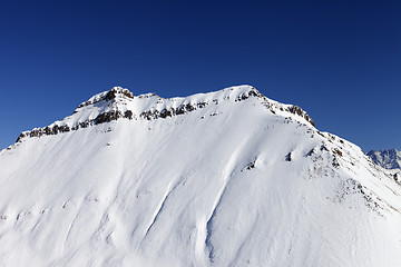 Image showing Snowy rocks in sun day