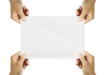 Image showing four hands holding sheet of paper