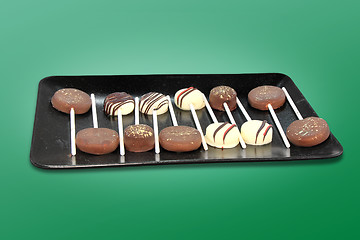 Image showing Chocolate candies on a stick