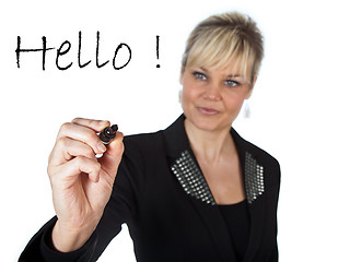 Image showing Studio portrait of a cute blond girl writing on a transparent wa