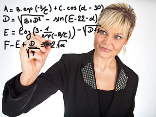 Image showing Studio portrait of a cute blond girl writing on a transparent wa