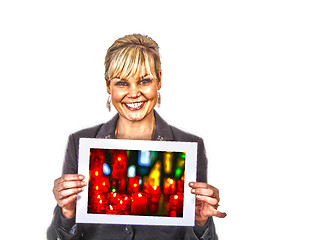 Image showing Studio portrait of a cute blond girl holding a piece of paper