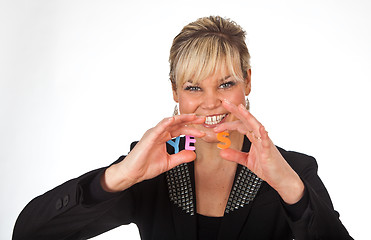 Image showing Studio portrait of a cute blond girl holding two letters forming